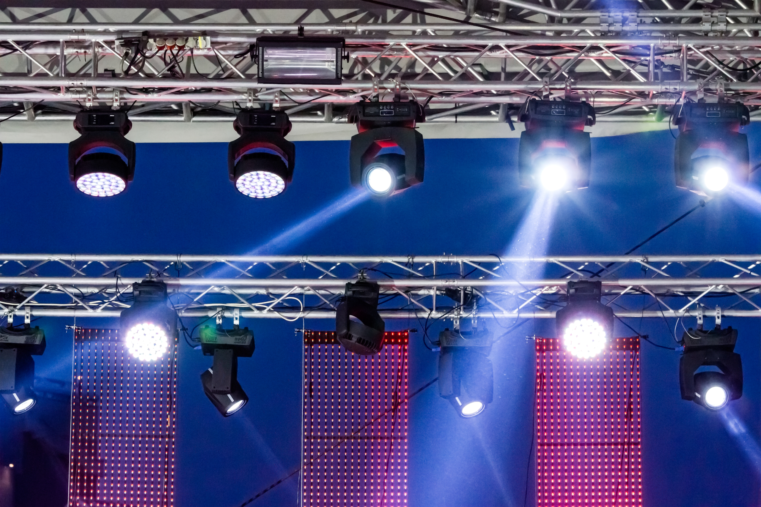 stage spotlight with light beams. lighting equipment high above an outdoor concert stage.